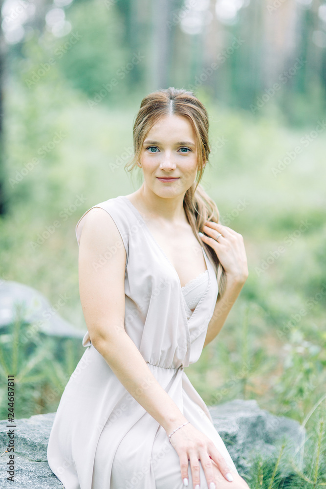 Boudoir photo shoot of the bride in the woods with a bouquet. Flying dress and beautiful girl in the Park. Boudoir photo shoot of the bride in the woods with a bouquet. Flying dress and beautiful girl in the Park.