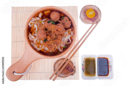 Delicious homemade Bakso, famous traditional Indonesian street food, meatballs with noodles served with chili saucel and soy sauce isolated on white background photo