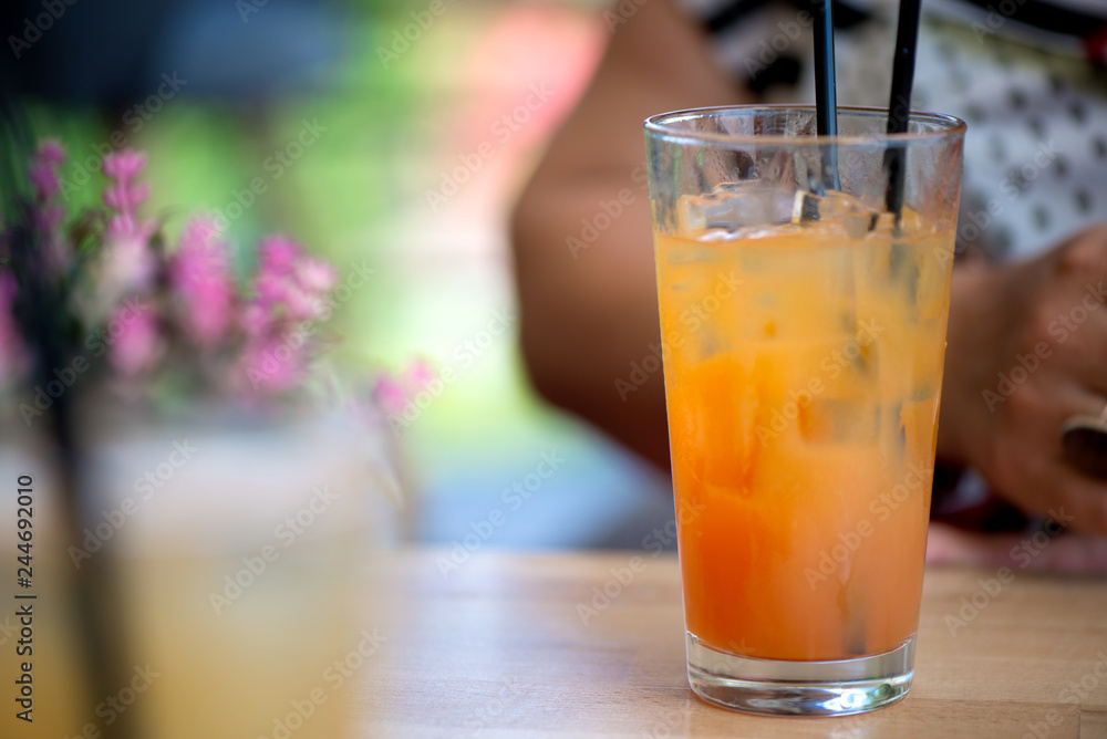 Glass of alcoholic tequila sunrise or campari and grenadine cocktail with juice in restaurant of bar. Concept of luxury holidays and vacation. Woman holding full glass of cold, refreshing beverage Glass of alcoholic tequila sunrise or campari and grenadine cocktail with juice in restaurant of bar. Concept of luxury holidays and vacation. Woman holding full glass of cold, refreshing beverage