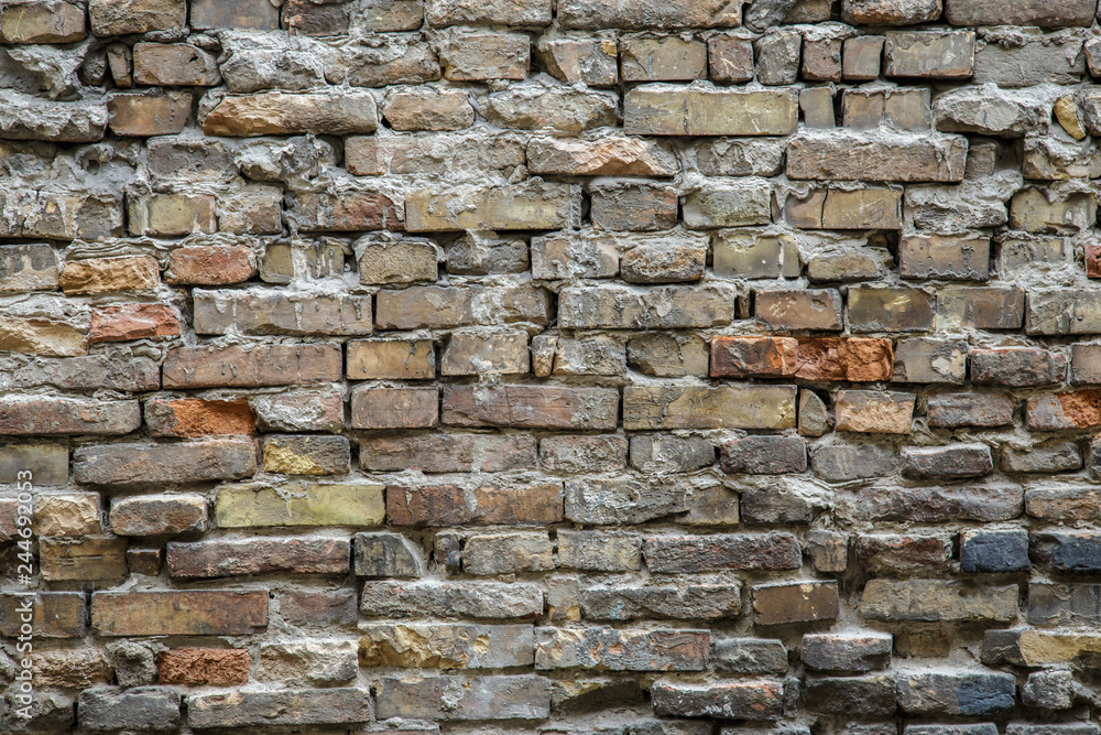 Background of old vintage dirty brick wall with peeling plaster, texture