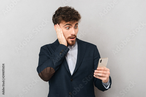Shocked young businessman wearing suit