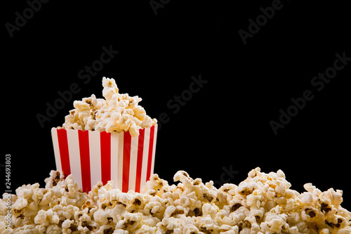 Box of fresh popcorn on black background