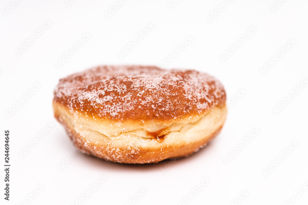 Traditional German or Austrian fried donuts with no hole, so called Krapfen, Berliner or Pfannkuchen with cinnamon sugar and filled with rose hip, raspberry or strawberry jam, party or carnival food