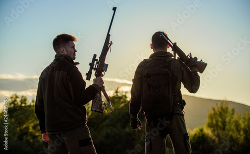Hunters friends gamekeepers with guns silhouette sky background. Hunters rifles nature environment. That was great day. Finish hunting season. Enjoy sunset in mountains. Hunters friends enjoy leisure