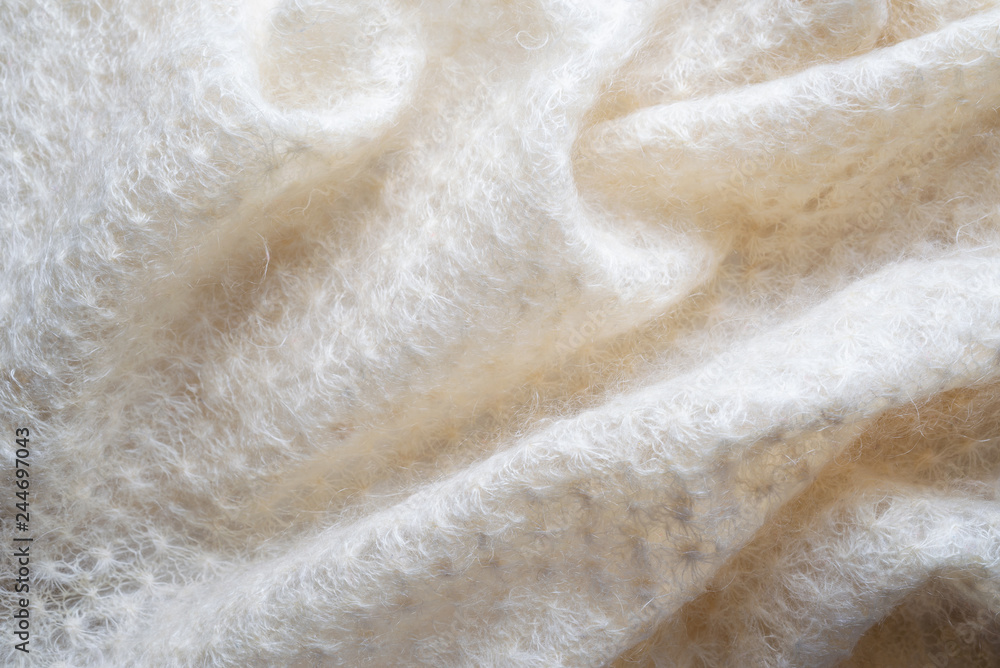 Soft folds of a white goat fluff scarf to be used as background
