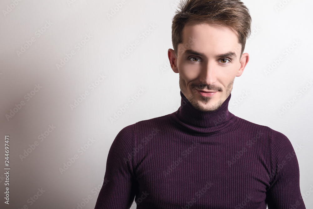 Handsome young elegant man in violet golf. Handsome young elegant man in violet golf.
