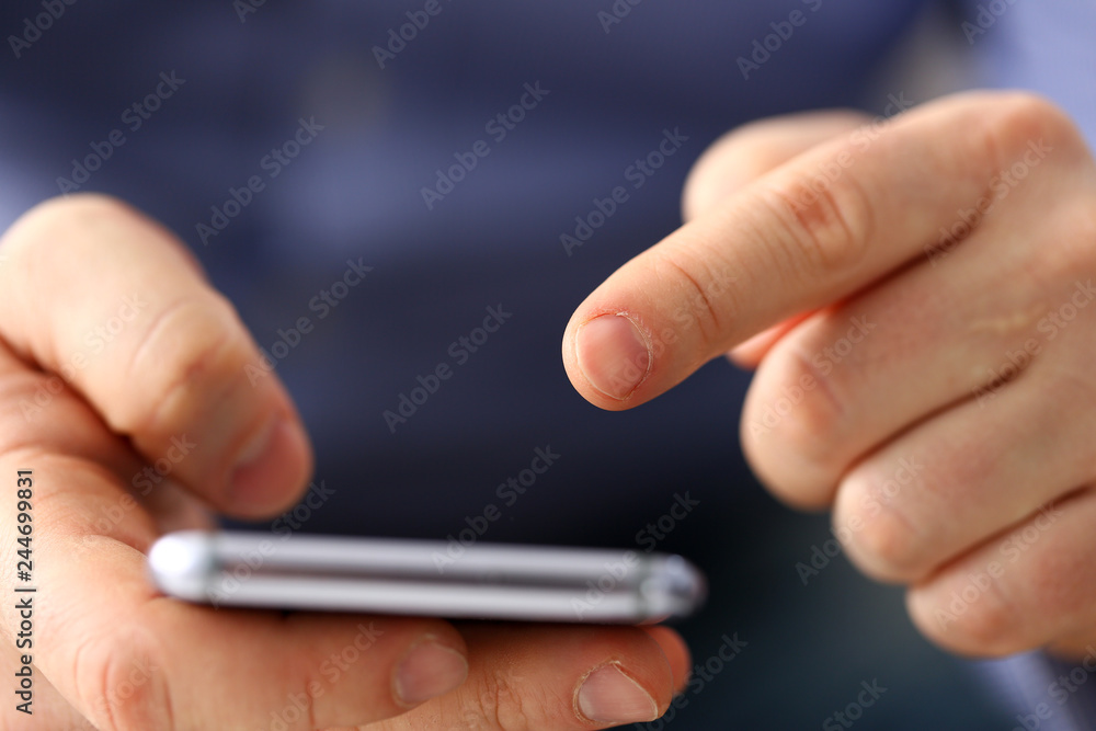 Businessman arm using modern cell phone closeup Businessman arm using modern cell phone closeup
