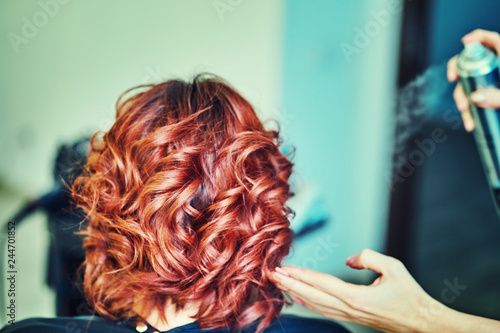 Image of a hairdresser applying extensions to a client's hair