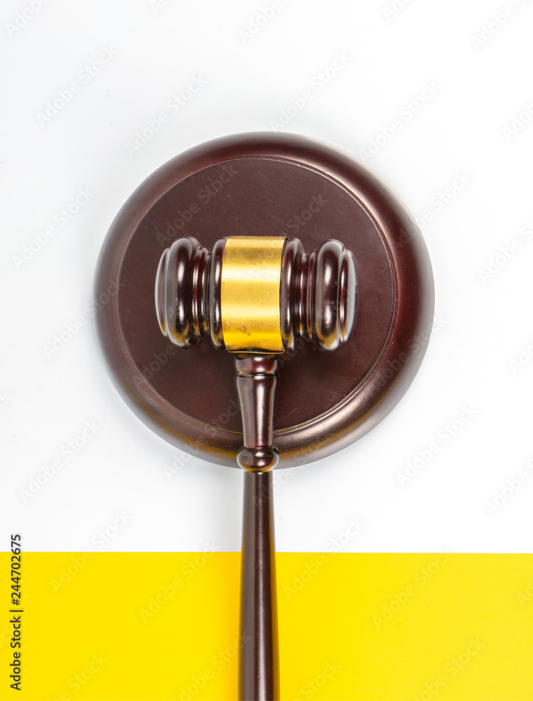 Gavel hammer with yellow background Gavel hammer with yellow background