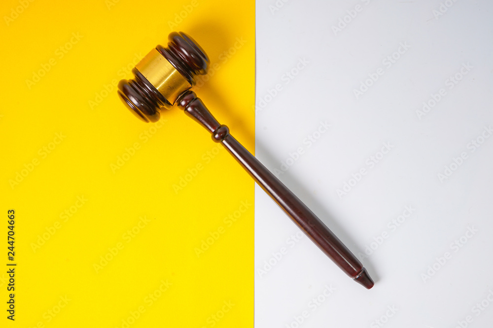 Gavel hammer with yellow background Gavel hammer with yellow background