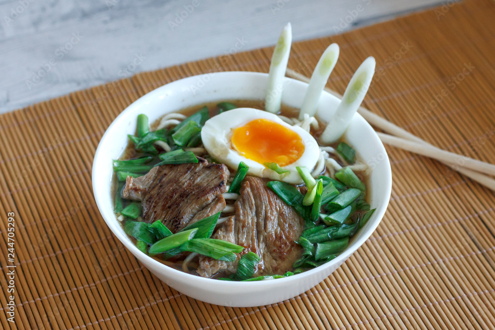Ramen soup with fresh onions, boiled egg and fried meat Ramen soup with fresh onions, boiled egg and fried meat