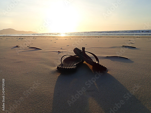 Beautiful sunset view with sandal on the sandy beach.     