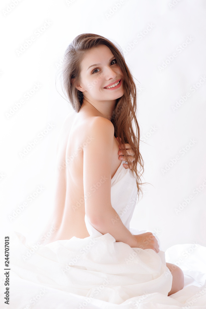 brunette woman lying on bed in bedroom brunette woman lying on bed in bedroom