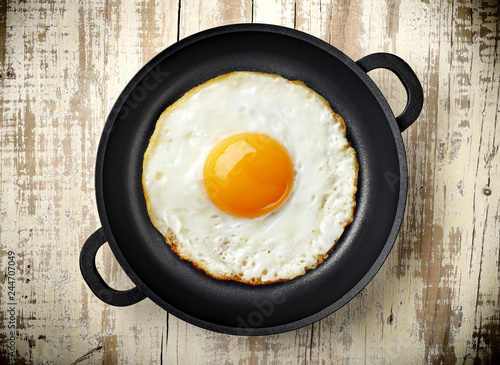 fried egg in an iron pan