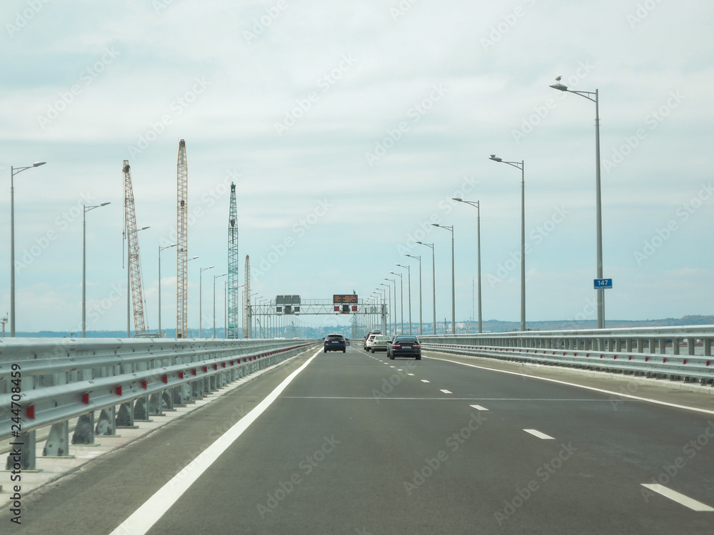 Cars go on a new wide road bridge Cars go on a new wide road bridge