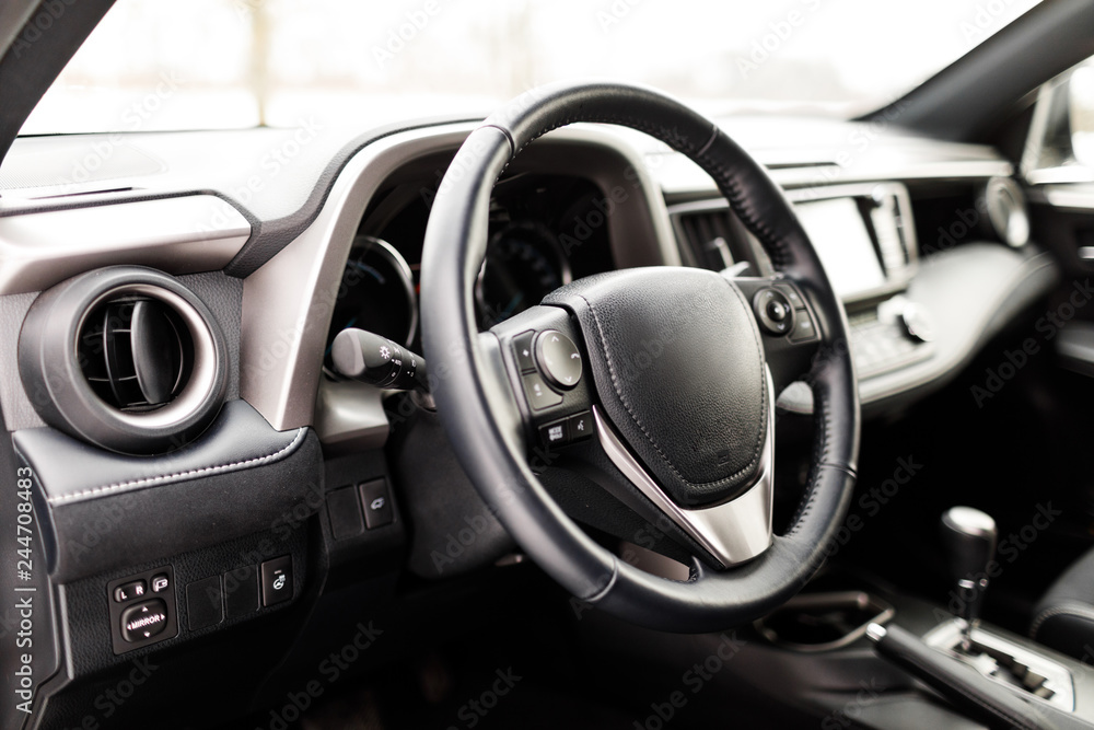Luxury prestige car interior, dashboard, steering wheel.