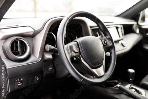 Luxury prestige car interior, dashboard, steering wheel. © VAKSMANV