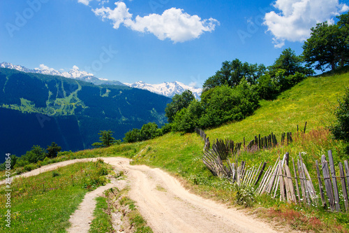 Georgian nature landscape. Summer mountain landscape in Svaneti with road to village