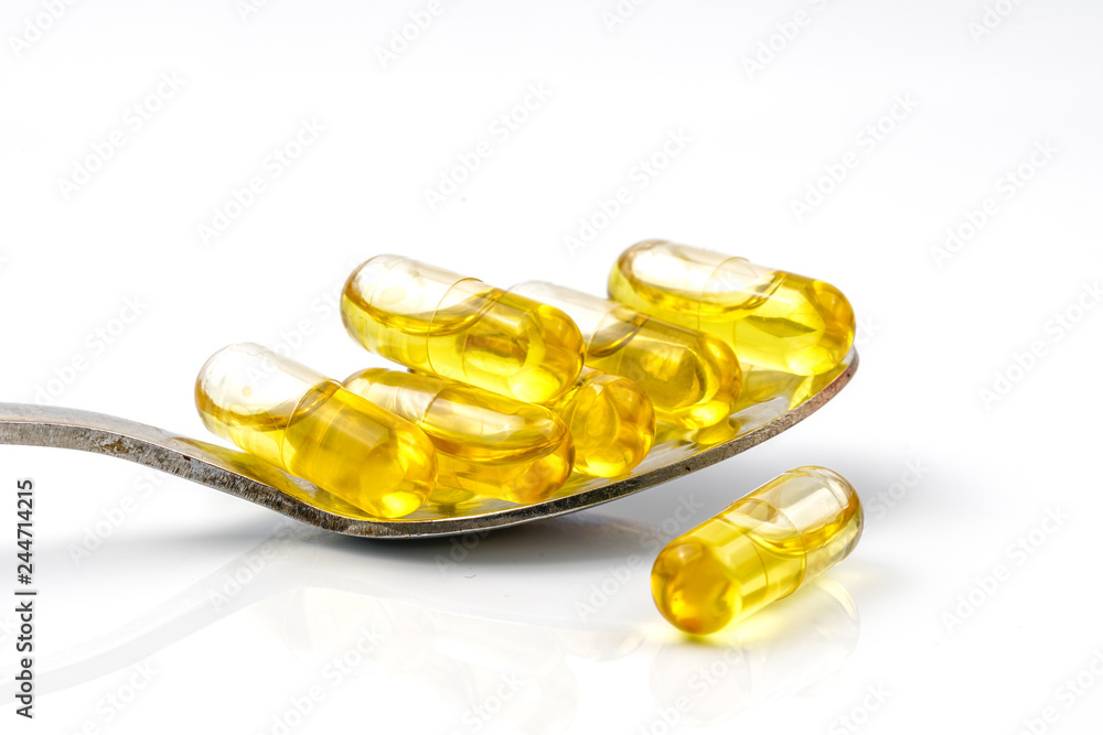 Olive capsules and spoon with white background. Olive capsules and spoon with white background.