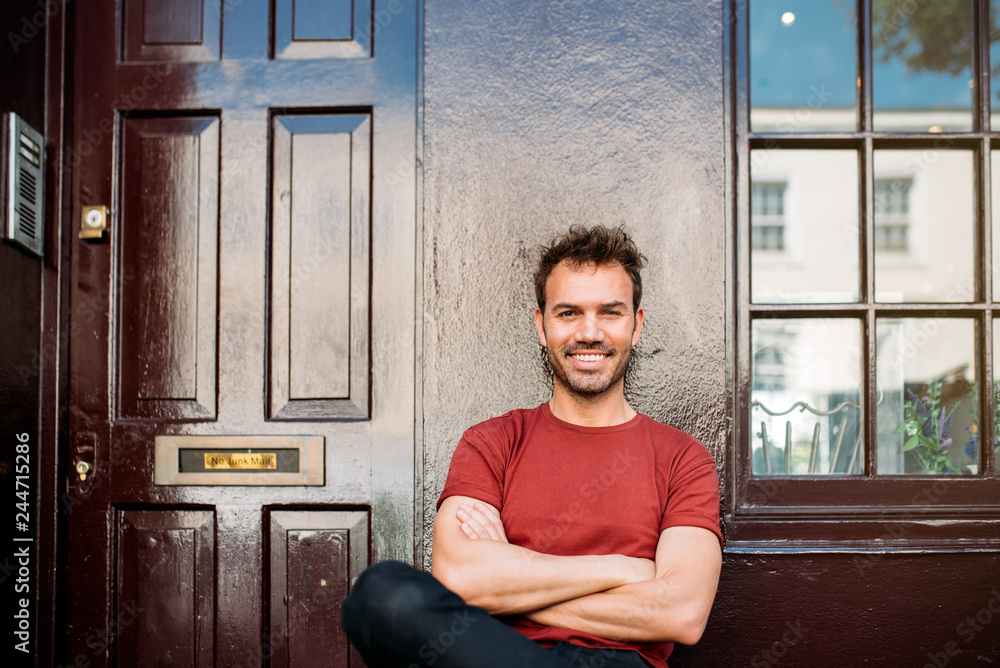 Man sitting in a bench on a beautiful maroon background Man sitting in a bench on a beautiful maroon background