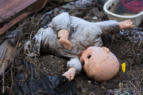 old dirty doll  on a burned ground