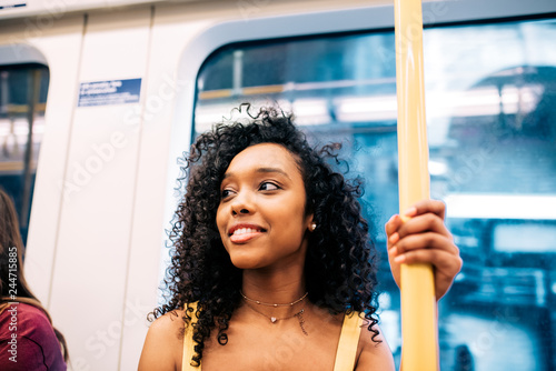 Photography Happy black woman on London underground