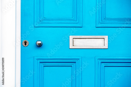 Fotografie Beautiful blue door with letterbox in a white house facade in Notting Hill