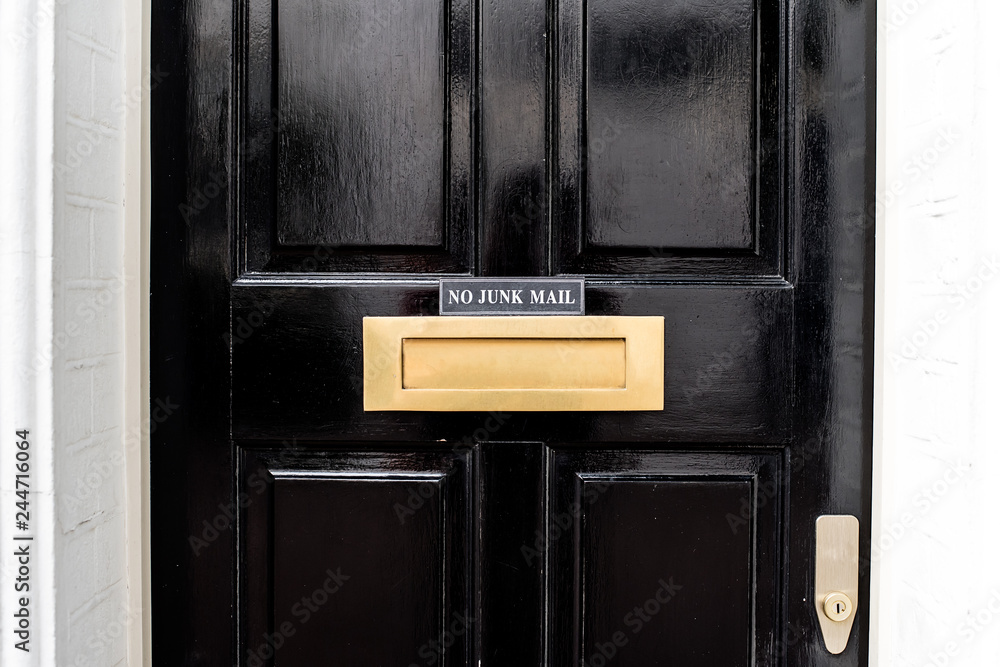 Beautiful black door with letterbox in a white house facade in Notting Hill Beautiful black door with letterbox in a white house facade in Notting Hill