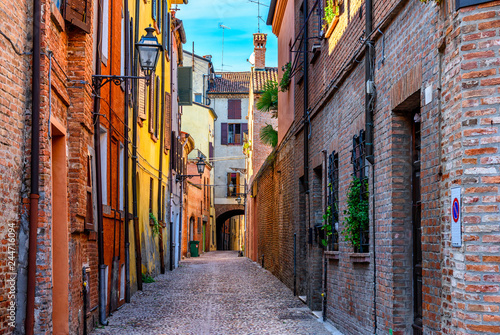 Old narrow street with arch in Ferrara, Italy. Ferrara is capital of the Province of Ferrara