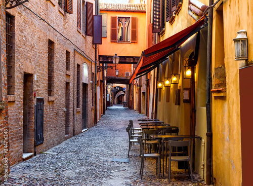 Fototapeta Naklejka Na Ścianę i Meble -  Cozy street with old houses in Ferrara, Emilia-Romagna, Italy. Ferrara is capital of the Province of Ferrara.