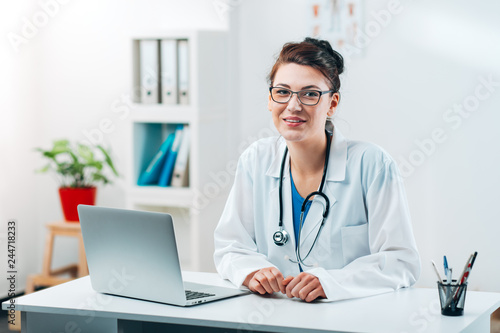 Portrait of Woman Doctor at her Medical Office Smiling