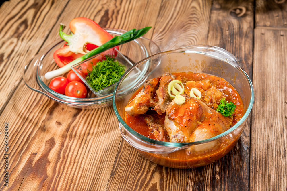 Roasted rabbit with herbs, tomato sauce and glass of wine on a plate. Roasted rabbit with herbs, tomato sauce and glass of wine on a plate.