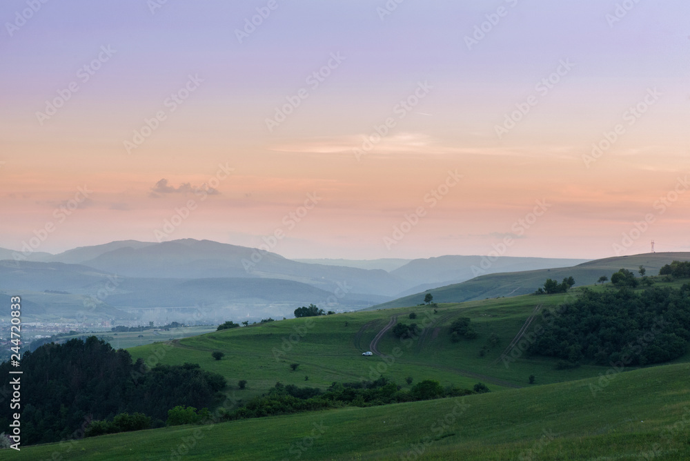 Fototapeta premium Romantic, bright and colorful sunset over a mountain range in Transylvania. Beautiful, colorful autumn background. 