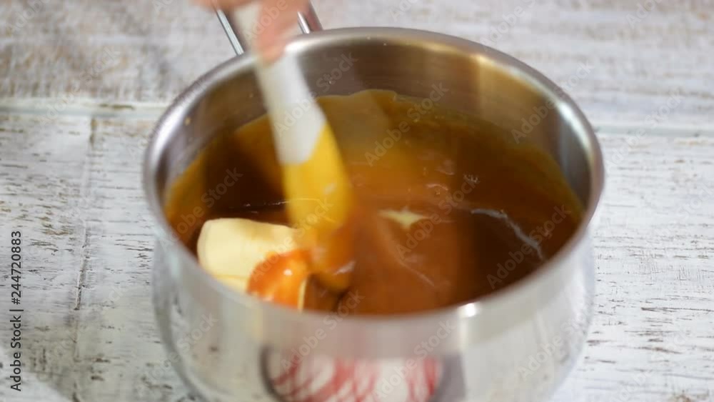 The process of making of the soft caramel at home. Adding and melting butter. The process of making of the soft caramel at home. Adding and melting butter.