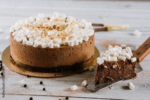 Big chocolate cake with marshmallows on white background