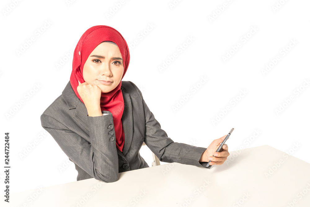 Businesswoman looking the handphone with muslimah lifestyle. Businesswoman looking the handphone with muslimah lifestyle.