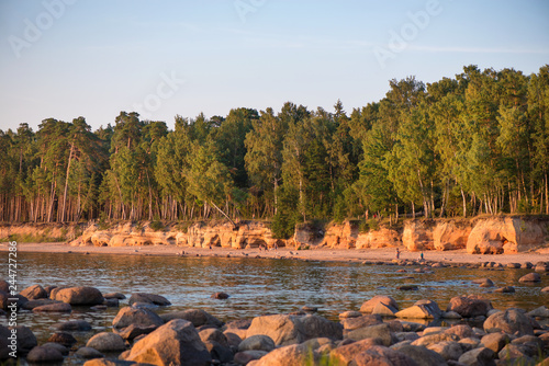 Veczemju cliffs on Baltic sea. Beautiful sea shore with limestone and sand caves and cliffs on each side next to forest. Calm, relaxing, meditation nature. Concept of romantic evening and holidays