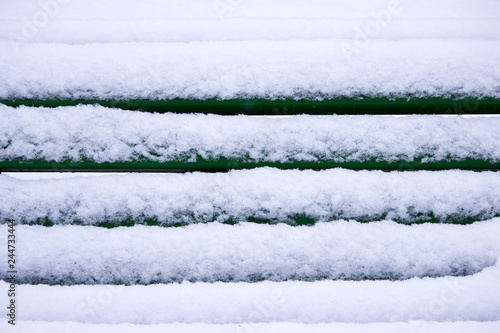Winter landscape with snowfall and snowdrifts. snow removal in Gatchina Park. bench covered with snow.