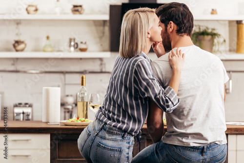 boyfriend and attractive girlfriend hugging in kitchen © LIGHTFIELD STUDIOS