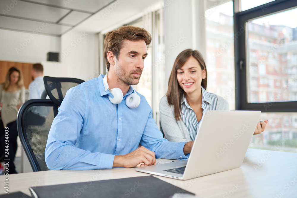 Two people in start up office, brainstorming about problems they encounter Two people in start up office, brainstorming about problems they encounter