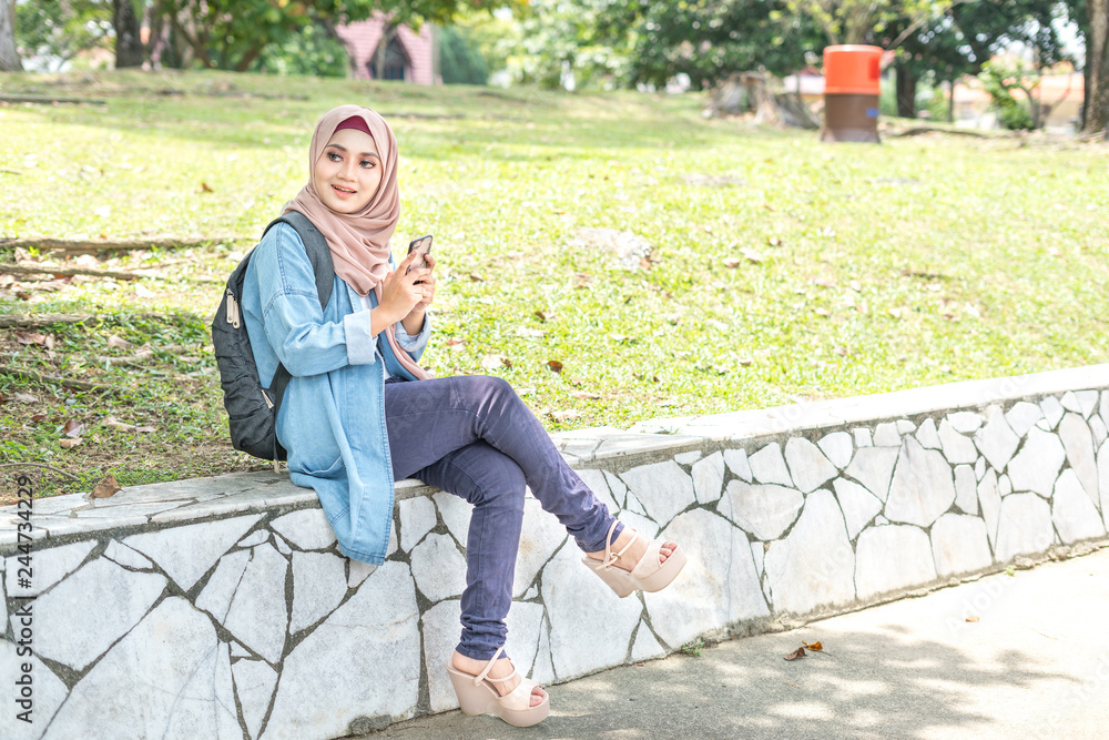 Fototapeta premium Veiled teenager at outdoor park.