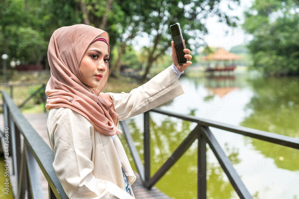 Veiled teenager at outdoor park. Veiled teenager at outdoor park.