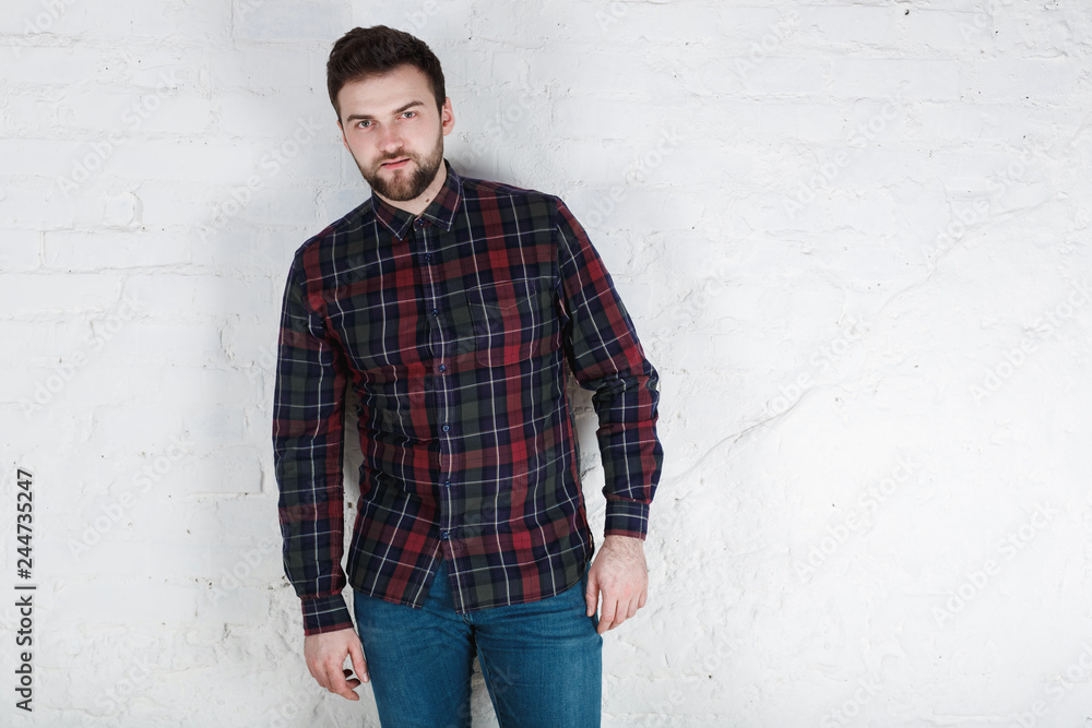 young friendly man doubting and confused, thinking of an idea or worried about something