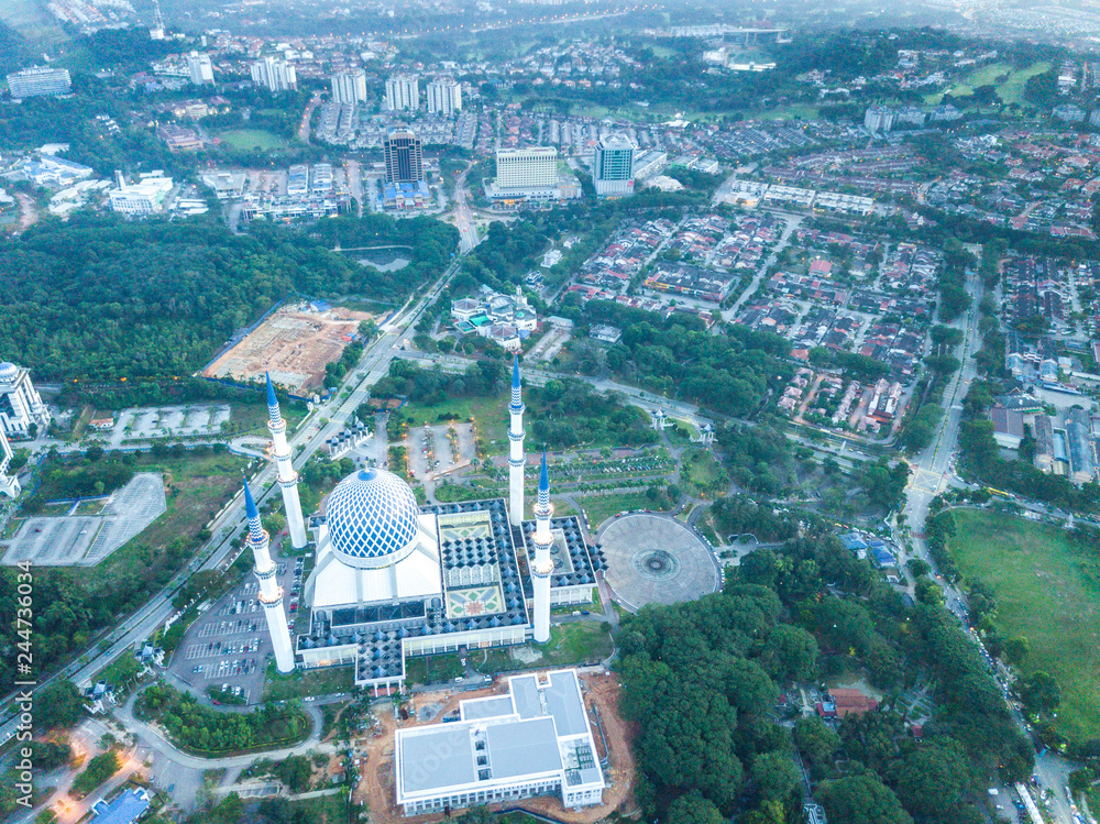 Aerial view of mosque at the center of township during sunrise.