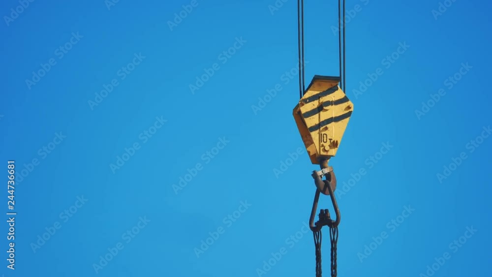 yellow lifting crane hook blue sky background. crane hook construction concept lifestyle a yellow lifting crane hook blue sky background. crane hook construction concept lifestyle a