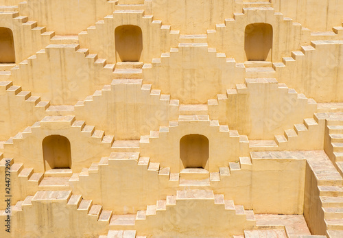 Beautiful Architecture Historic stepwell of Panna Meena Ka Kund near the Amber Fort. Constructed background of red sandstone and marble. Jaipur, Rajasthan, India photo