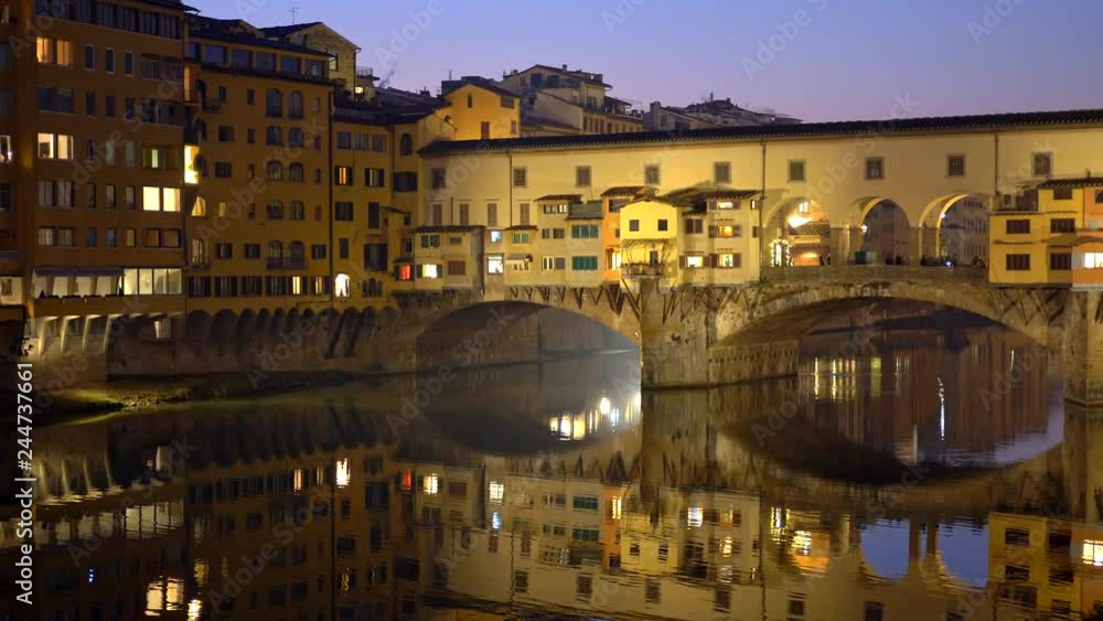 Night shot of illuminated Ponte Vecchio bridge and Arno River in Florence, Italy Night shot of illuminated Ponte Vecchio bridge and Arno River in Florence, Italy