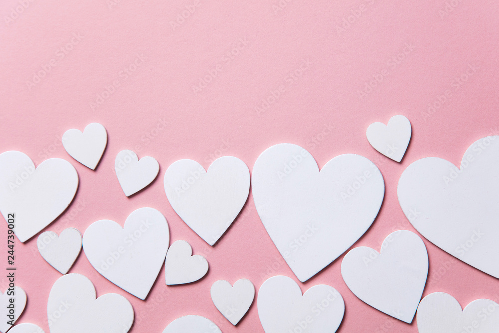 White hearts on a pastel pink background. 