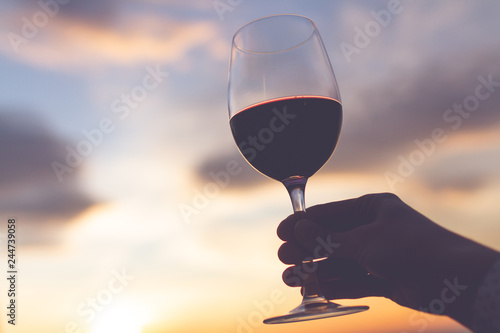 A glass wine at sunset in the evening.