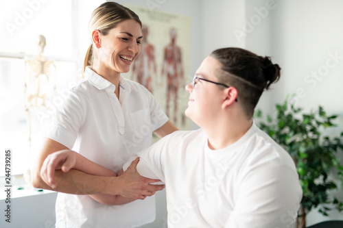 A Modern rehabilitation physiotherapy woman worker with client
